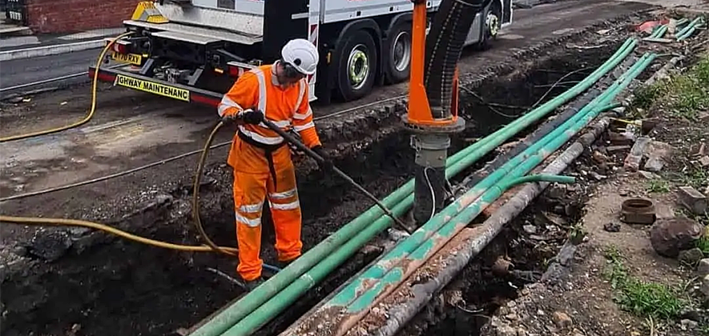A man using vacuum excavation around underground utilities