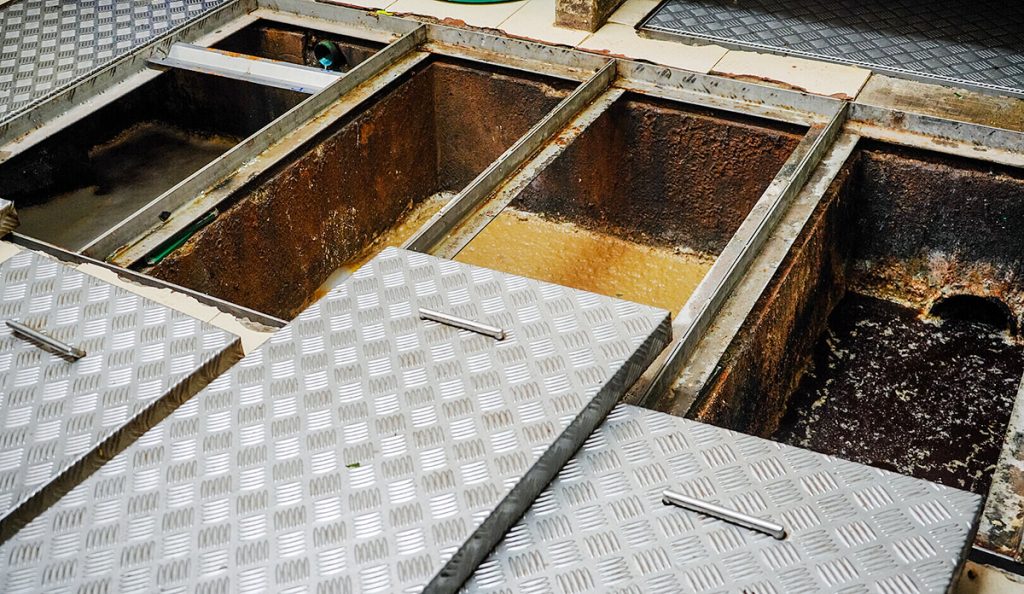 Several used grease traps which have been opened