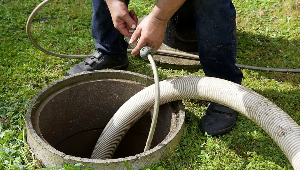 A person servicing a septic tank