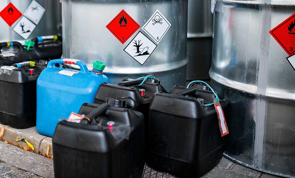 Plastic containers and steel barrels containing liquid waste
