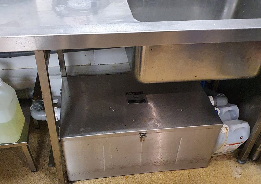 A grease trap in a kitchen