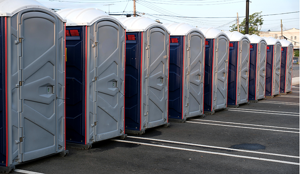 A row of grey portable toilets