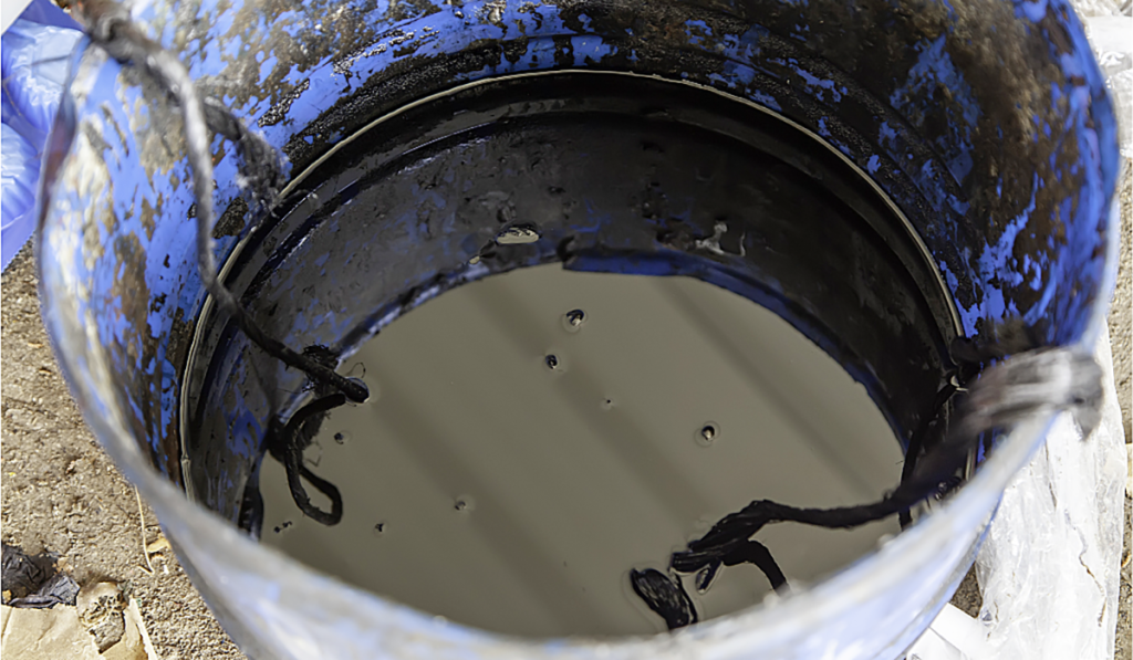 Container holding used oil collected for recycling, showing waste oil awaiting processing and responsible disposal.