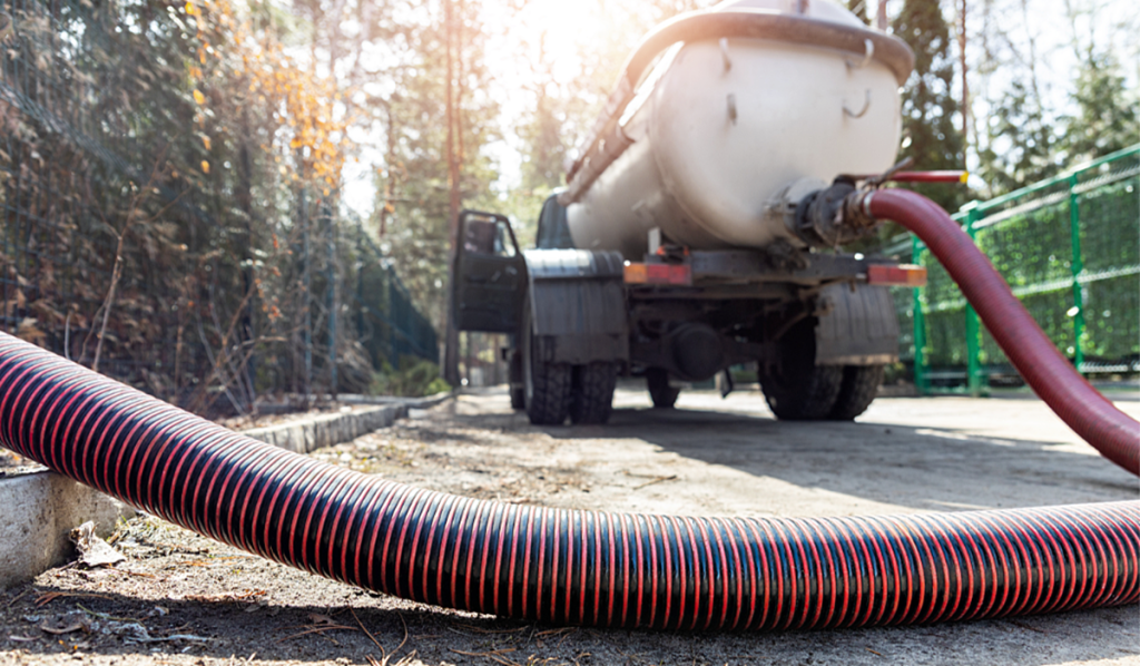 Tanker truck collecting bulk liquid waste at an industrial site