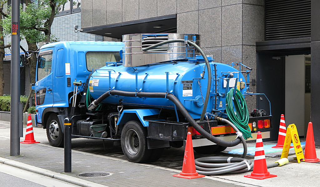 Vacuum loading truck removing waste from a commercial site